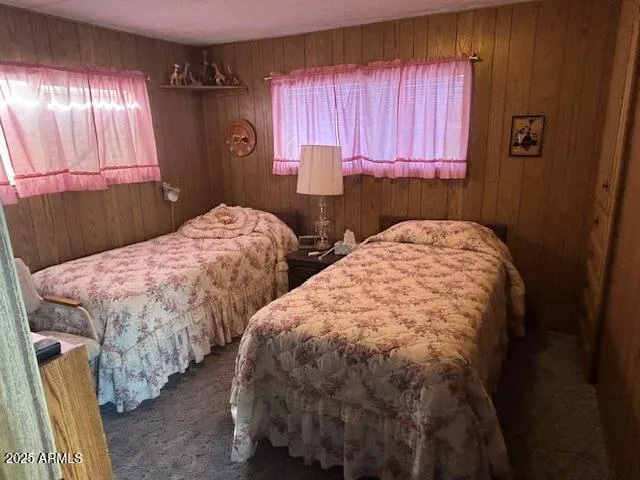 a bedroom with two beds and a window