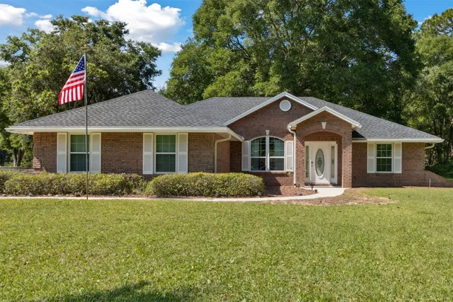 a front view of house with yard and green space
