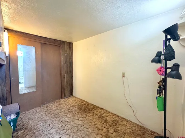 a bedroom with a bed and a potted plant