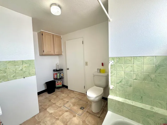 a bathroom with a toilet and shower