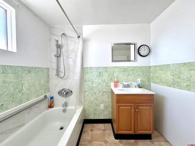 a bathroom with a sink mirror toilet and bathtub