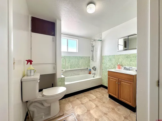 a bathroom with a sink toilet and bathtub