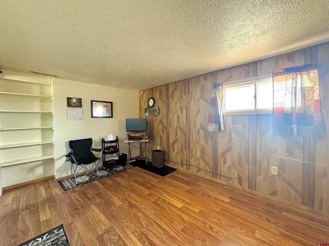 a living room with furniture a window and a wooden floor