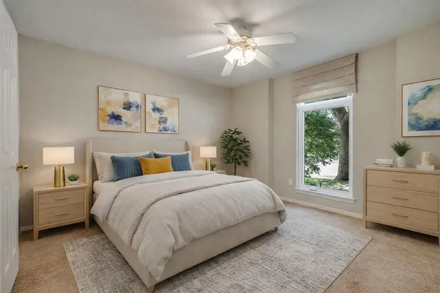 a bedroom with a large bed and a chandelier