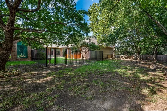 a view of a house with a yard and potted plants