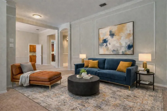 a view of a dining room with furniture a chandelier and window