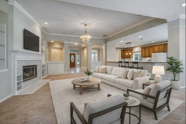 a living room with furniture ceiling fan and a rug