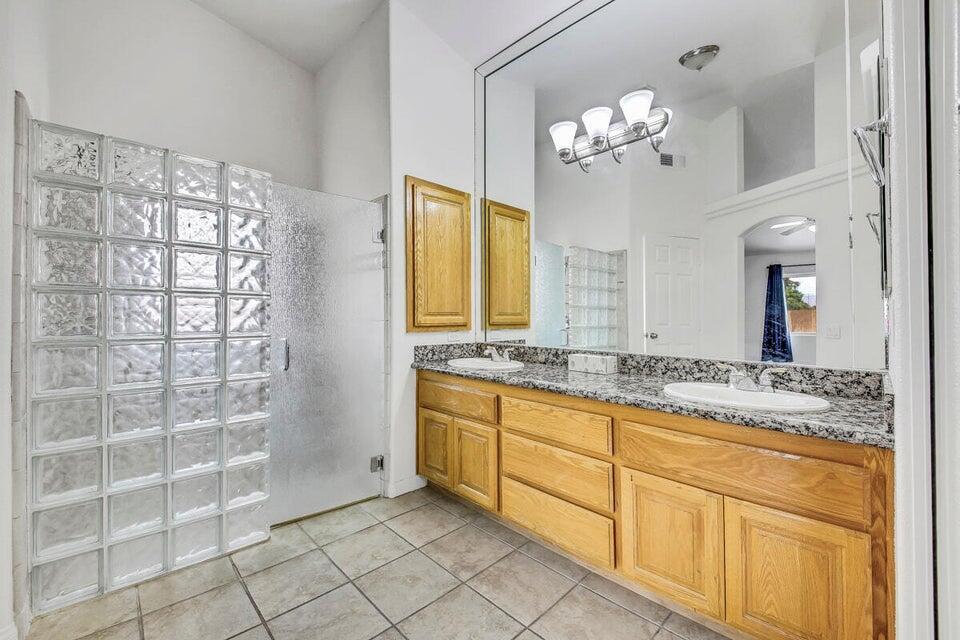 45625 Apache Road Indian Wells, CA 92210 - Photo 20 of 33 a bathroom with a granite countertop sink a large mirror and a shower