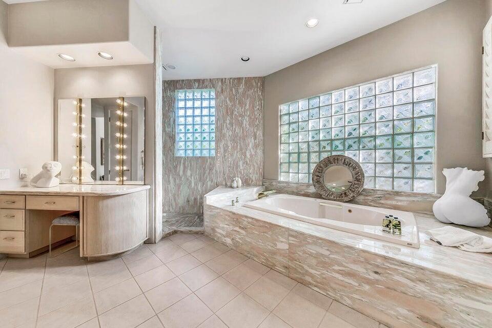 45625 Apache Road Indian Wells, CA 92210 - Photo 23 of 33 a spacious bedroom with a bed and a large window