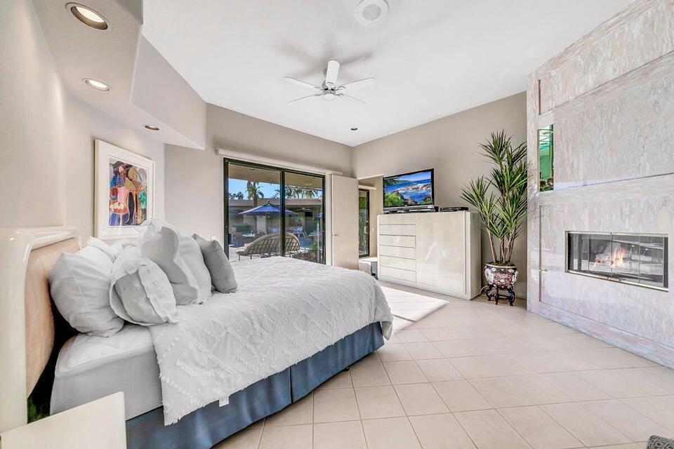 45625 Apache Road Indian Wells, CA 92210 - Photo 25 of 33 a bedroom with a bed couch and a fireplace