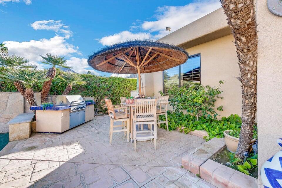 45625 Apache Road Indian Wells, CA 92210 - Photo 31 of 33 a table and chair sitting in patio with a potted plant
