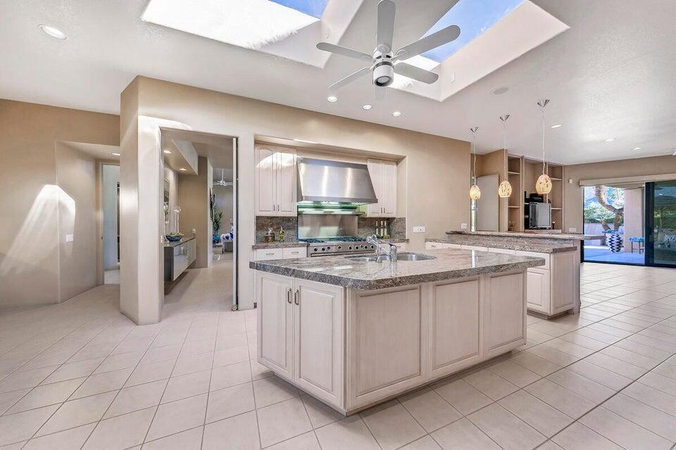 45625 Apache Road Indian Wells, CA 92210 - Photo 9 of 33 a kitchen with stainless steel appliances granite countertop a stove and a sink