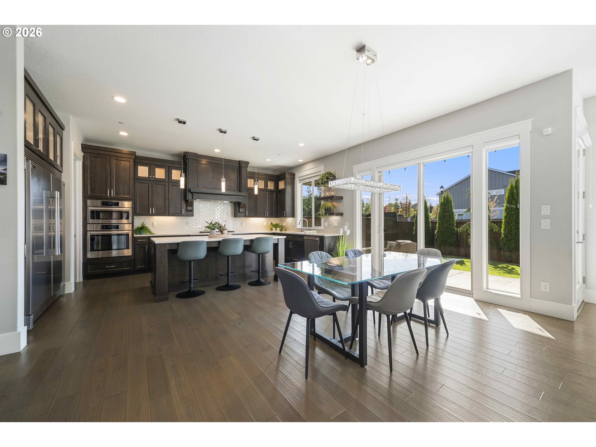 2036 Northwest 44th Avenue Camas, WA 98607 - Photo 11 of 48 a open kitchen with stainless steel appliances granite countertop a dining table chairs and granite counter tops