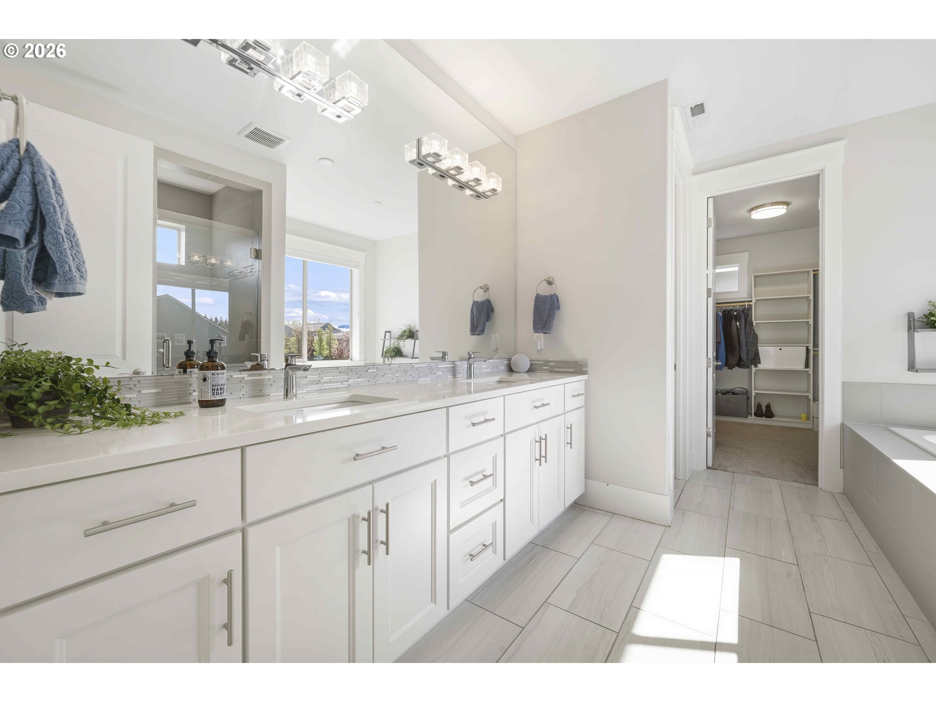 2036 Northwest 44th Avenue Camas, WA 98607 - Photo 22 of 48 a spacious bathroom with a double vanity sink a mirror and a bathtub