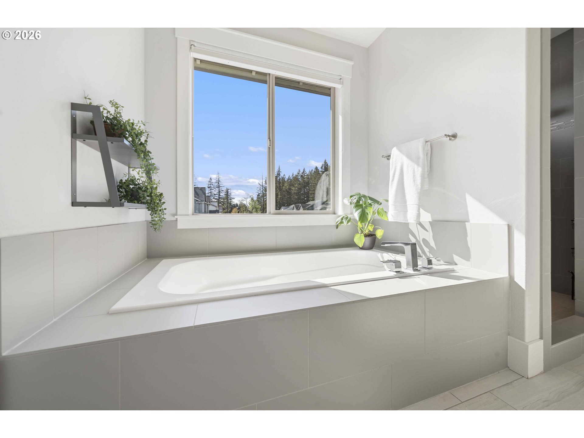 2036 Northwest 44th Avenue Camas, WA 98607 - Photo 23 of 48 a bathroom with a bathtub a sink and a window