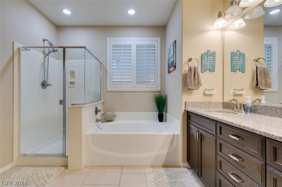 7375 Campbell Ranch Avenue Las Vegas, NV 89179 - Photo 26 of 45 A well-appointed bathroom offers both a walk-in shower and a built-in tub for ultimate relaxation.