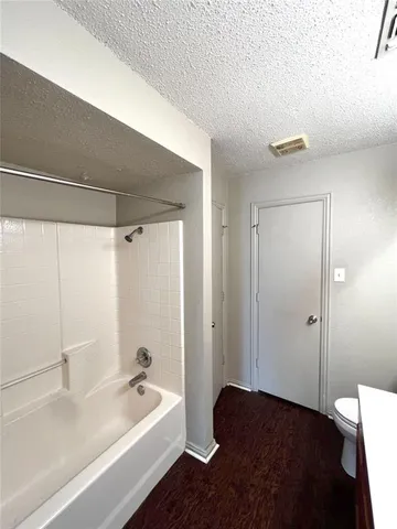 a bathroom with a bathtub and a sink