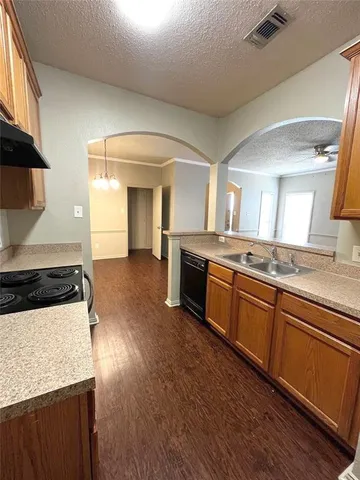 a large kitchen with granite countertop a stove and a sink