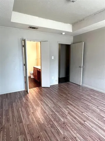 a view of a livingroom with wooden floor and a window
