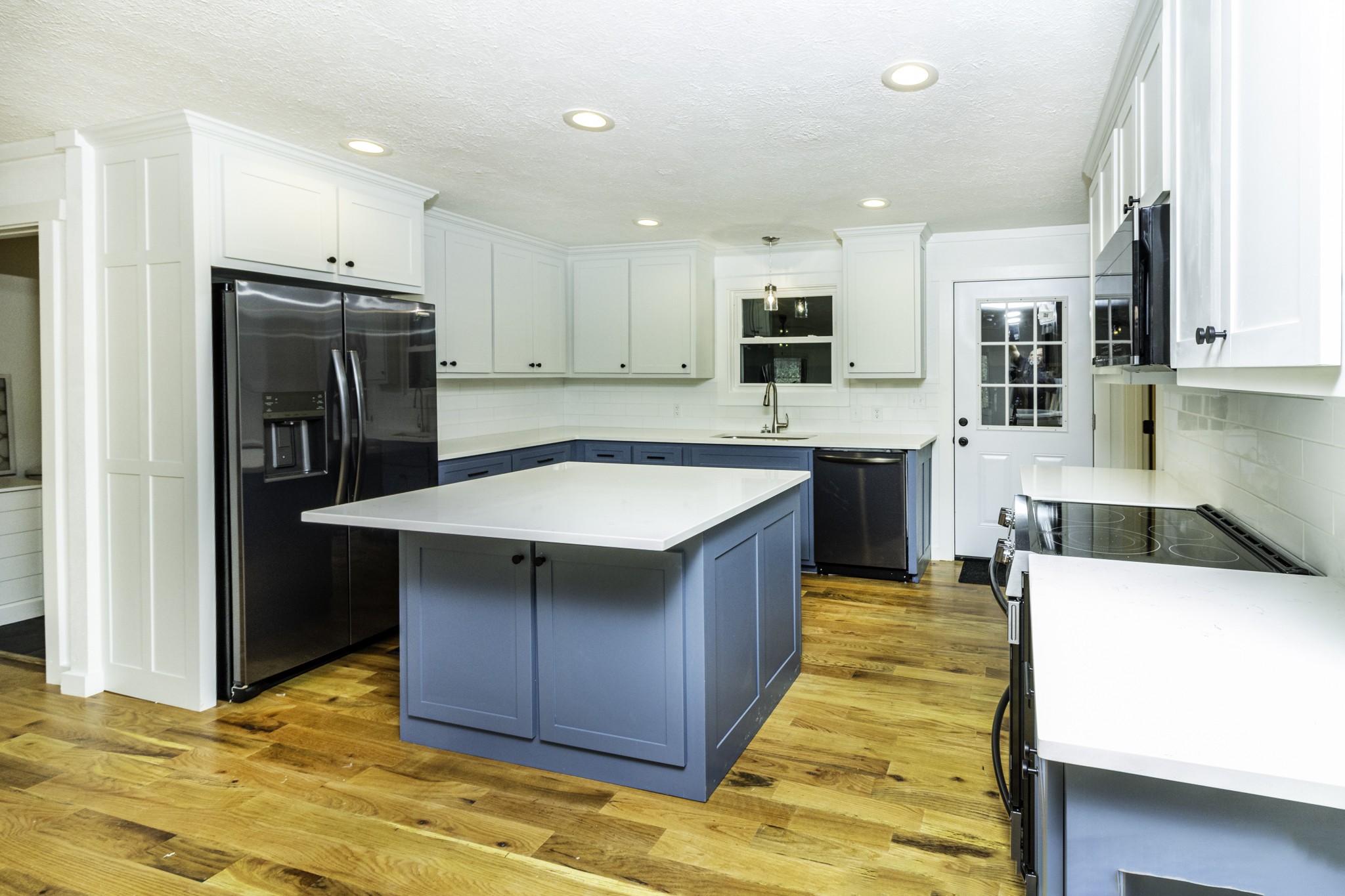 405 Napier Lake Road Hohenwald, TN 38462 - Photo 12 of 26 a kitchen with stainless steel appliances granite countertop a sink counter space and cabinets