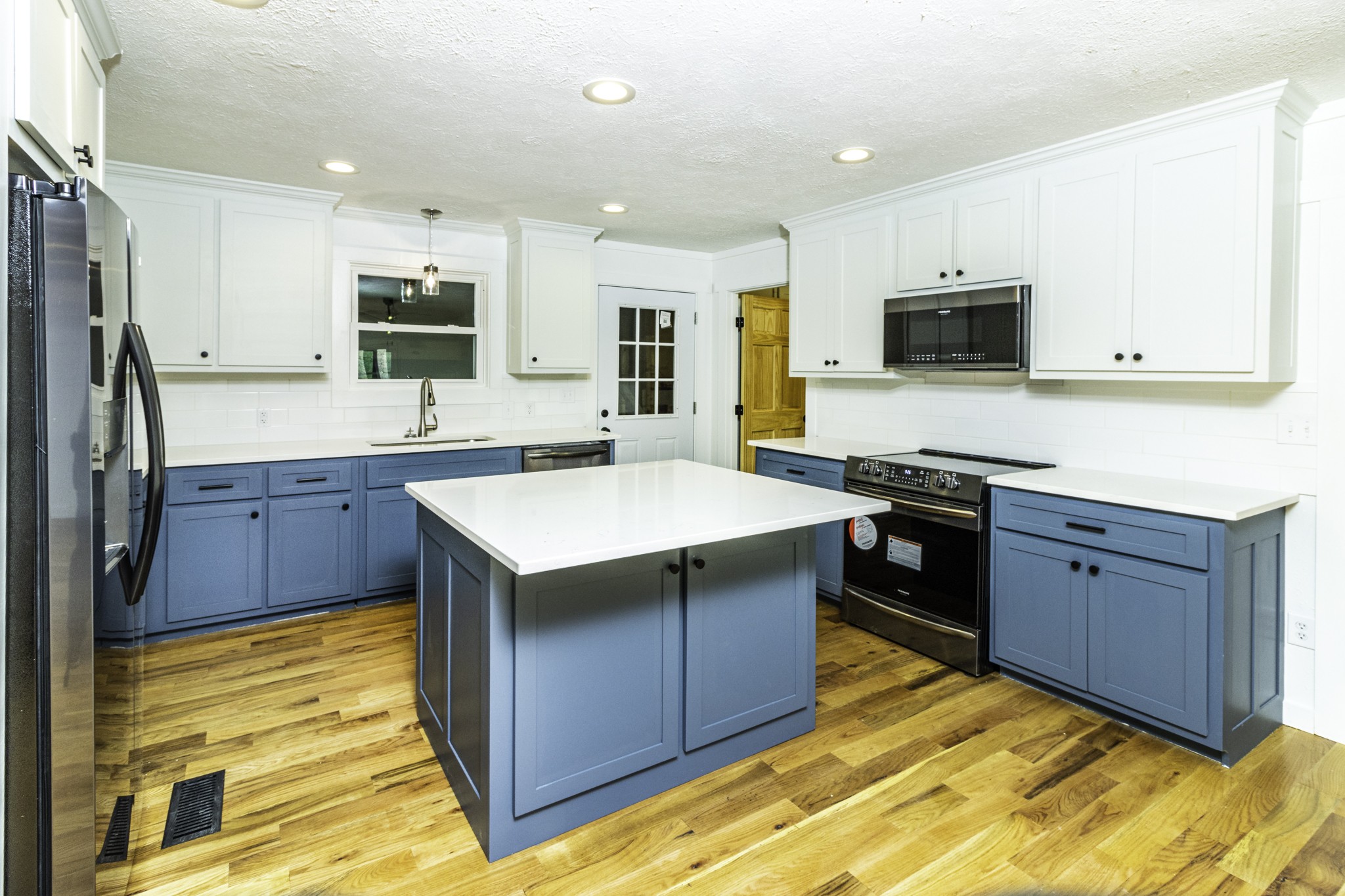 405 Napier Lake Road Hohenwald, TN 38462 - Photo 13 of 26 a kitchen with a sink stove top oven and microwave