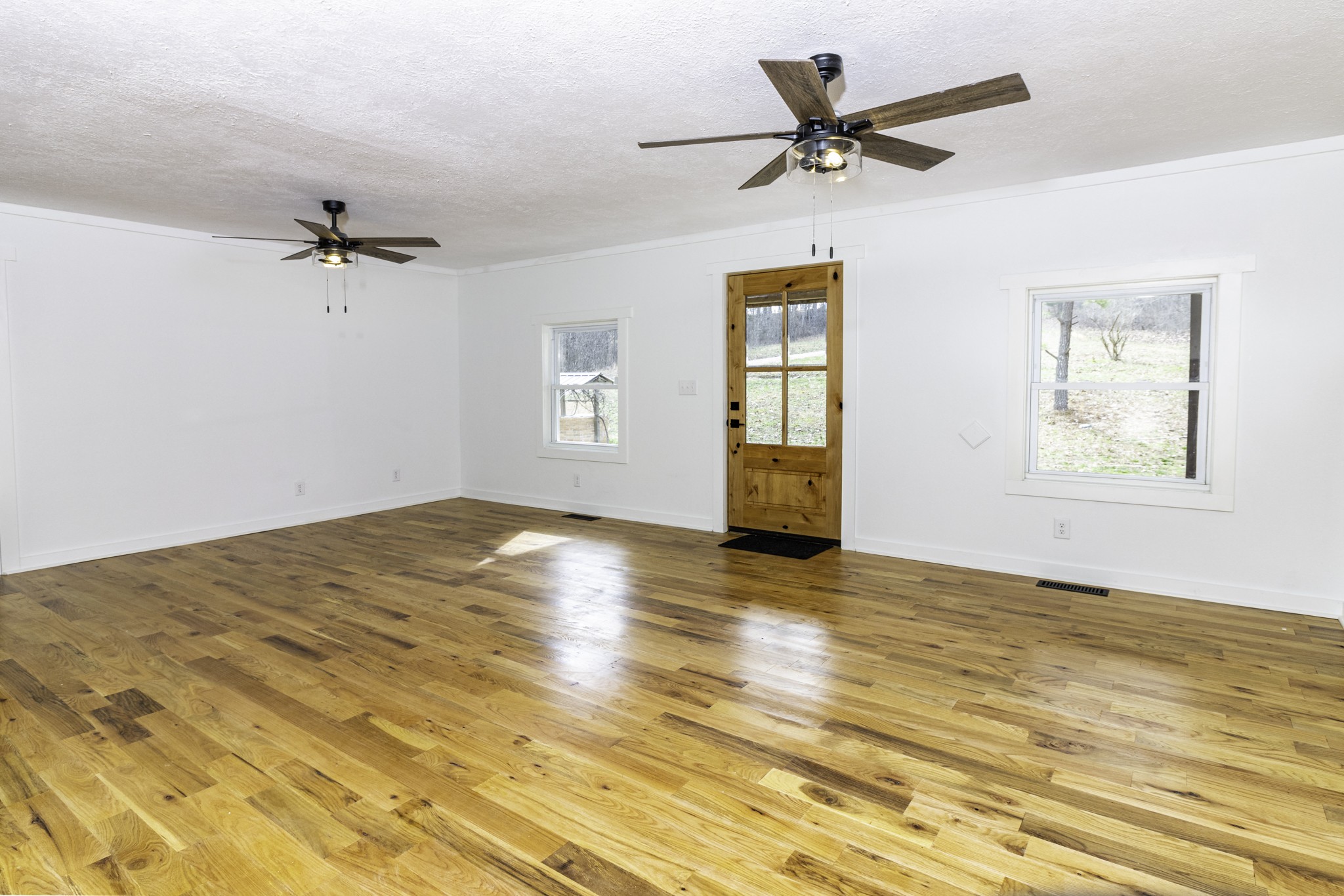 405 Napier Lake Road Hohenwald, TN 38462 - Photo 15 of 26 a view of empty room with wooden floor and fan