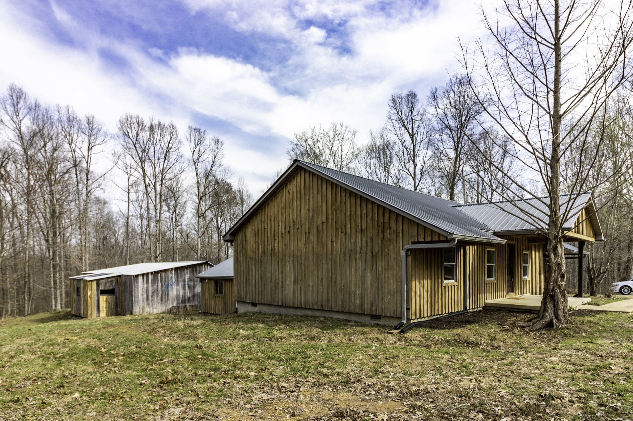 405 Napier Lake Road Hohenwald, TN 38462 - Photo 17 of 26 a house with trees in the background