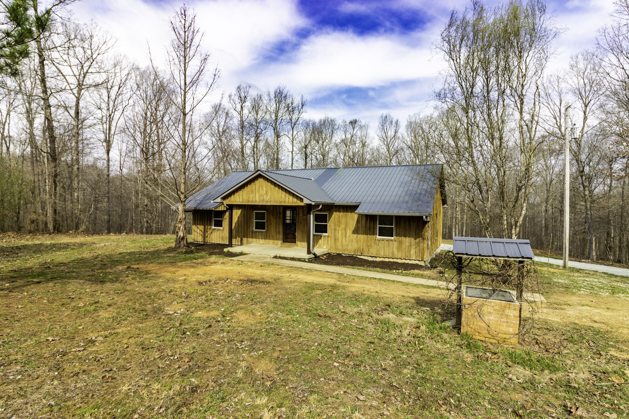 405 Napier Lake Road Hohenwald, TN 38462 - Photo 2 of 26 a front view of a house with a yard