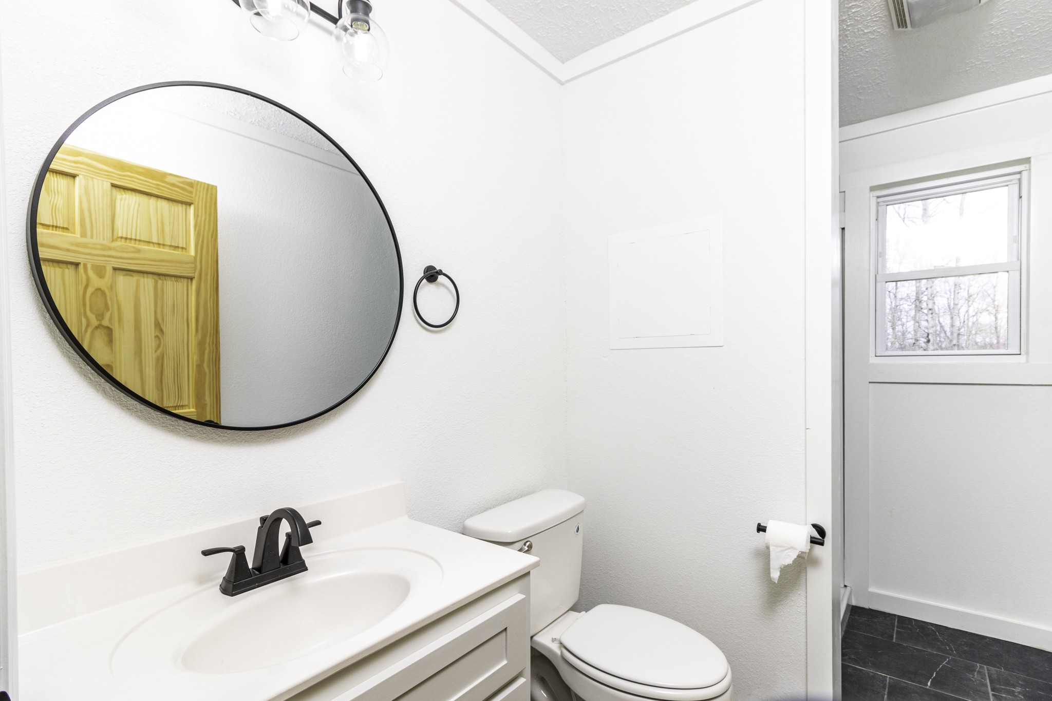 405 Napier Lake Road Hohenwald, TN 38462 - Photo 23 of 26 a bathroom with a sink mirror and toilet