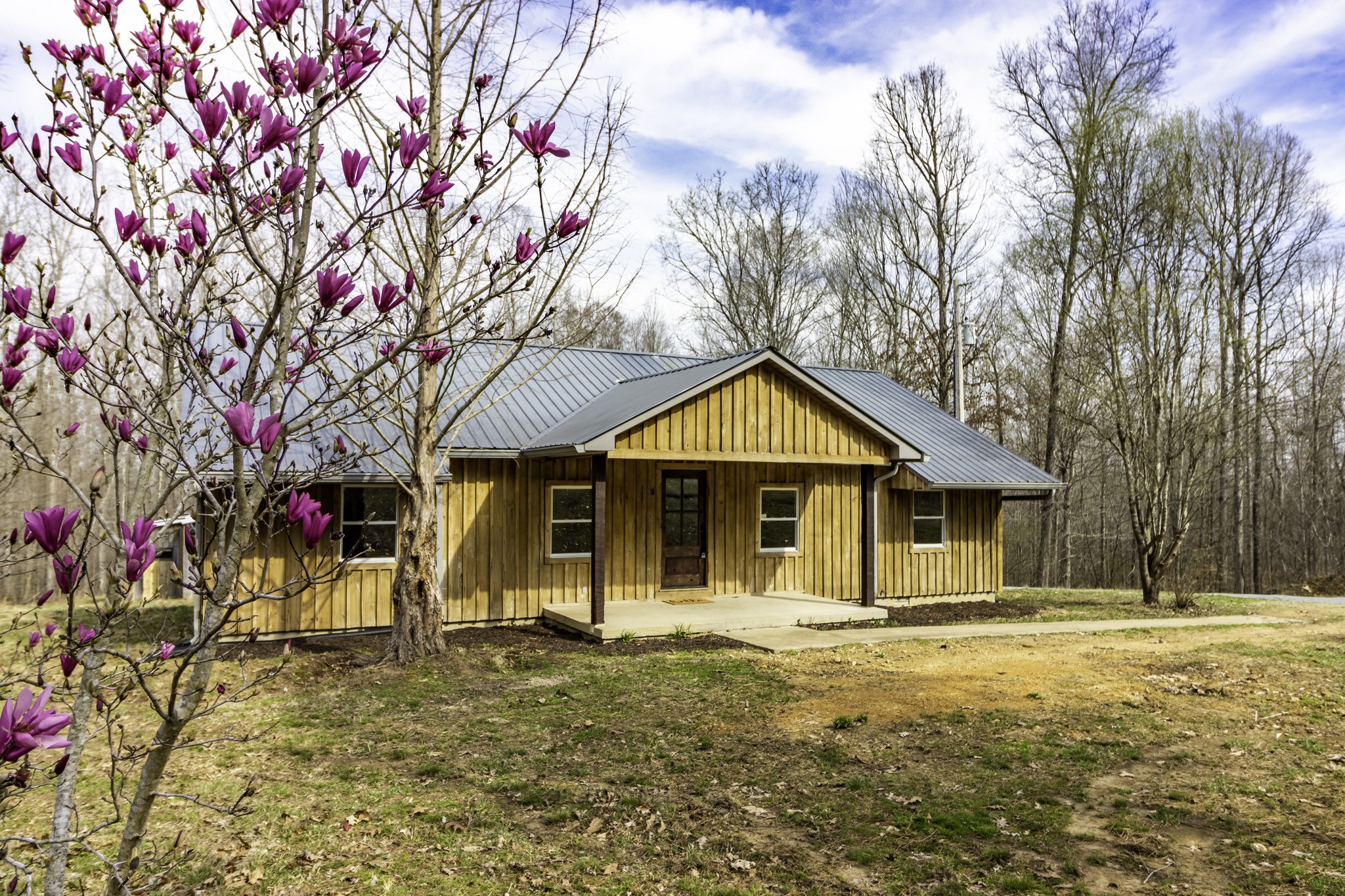 405 Napier Lake Road Hohenwald, TN 38462 - Photo 3 of 26 a front view of a house with a yard