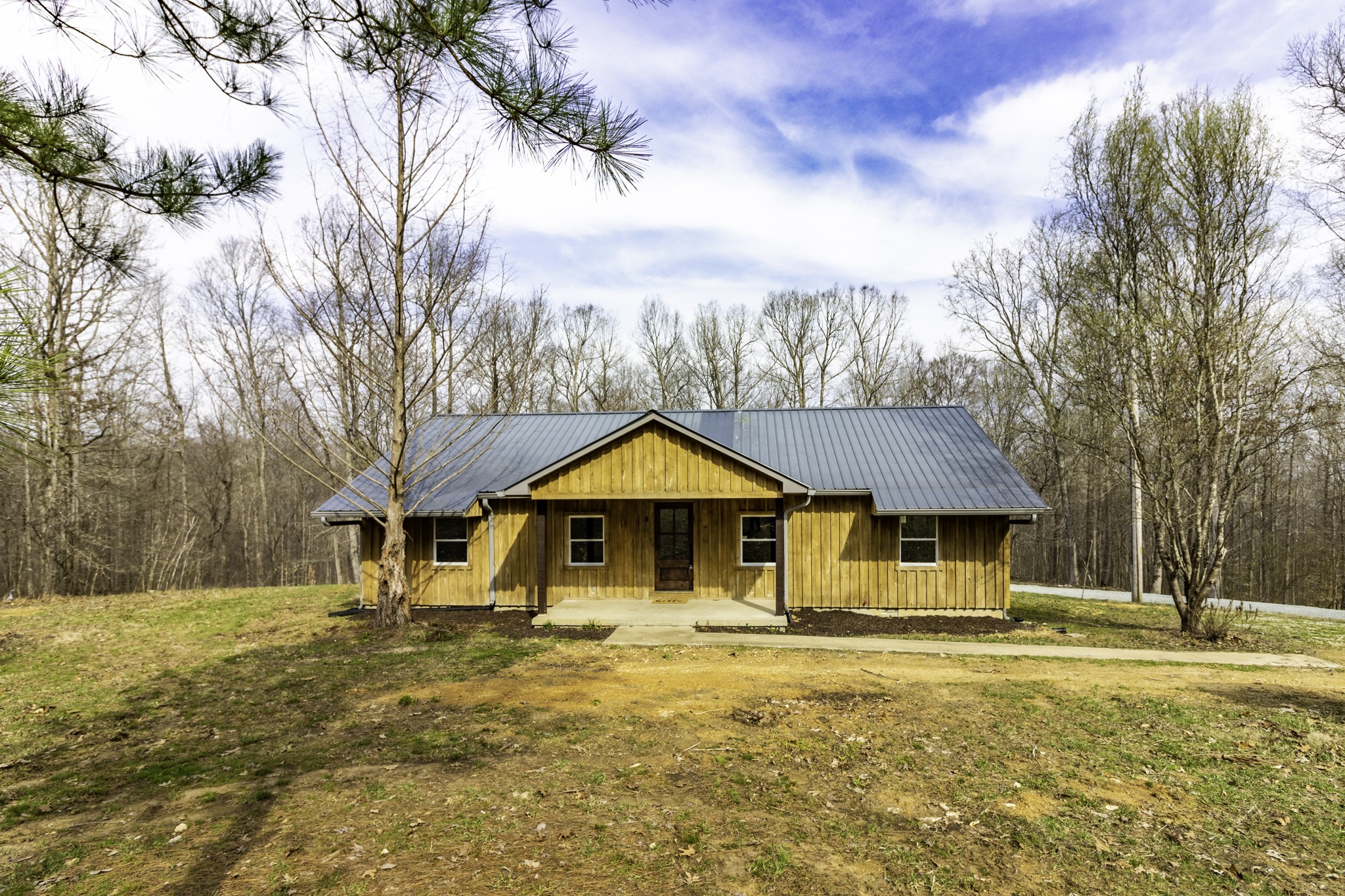 405 Napier Lake Road Hohenwald, TN 38462 - Photo 5 of 26 a front view of a house with a yard