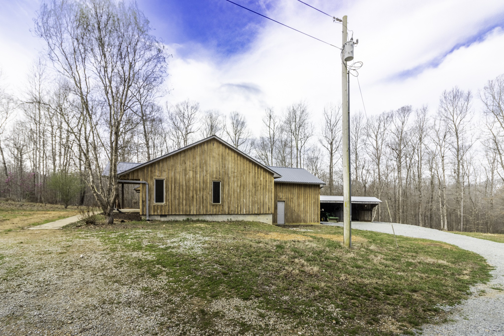 405 Napier Lake Road Hohenwald, TN 38462 - Photo 8 of 26 a house with trees in the background
