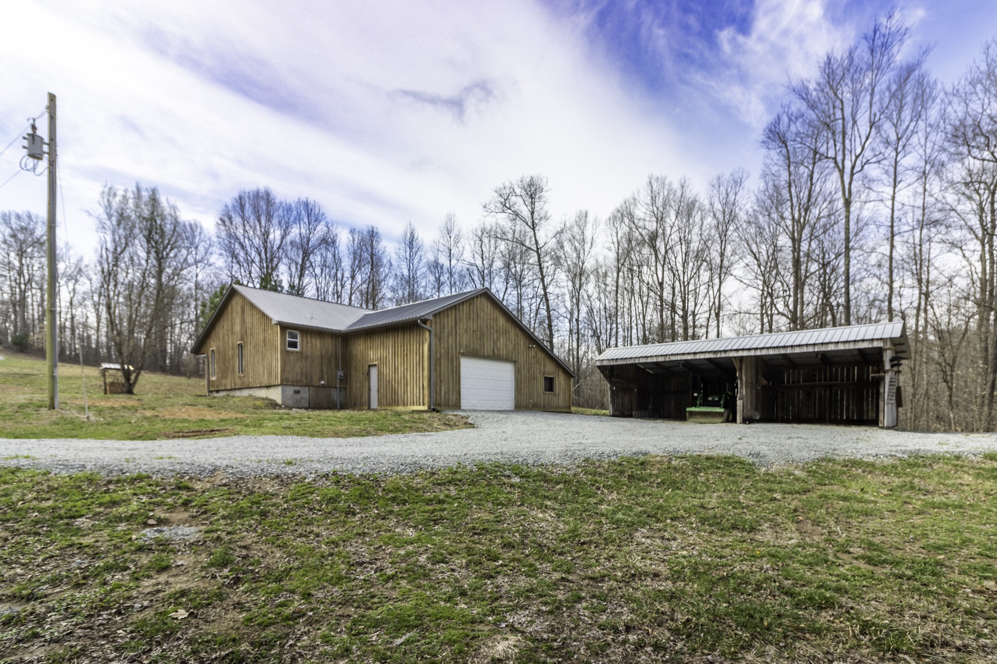 405 Napier Lake Road Hohenwald, TN 38462 - Photo 10 of 26 a front view of a house with a yard and garage