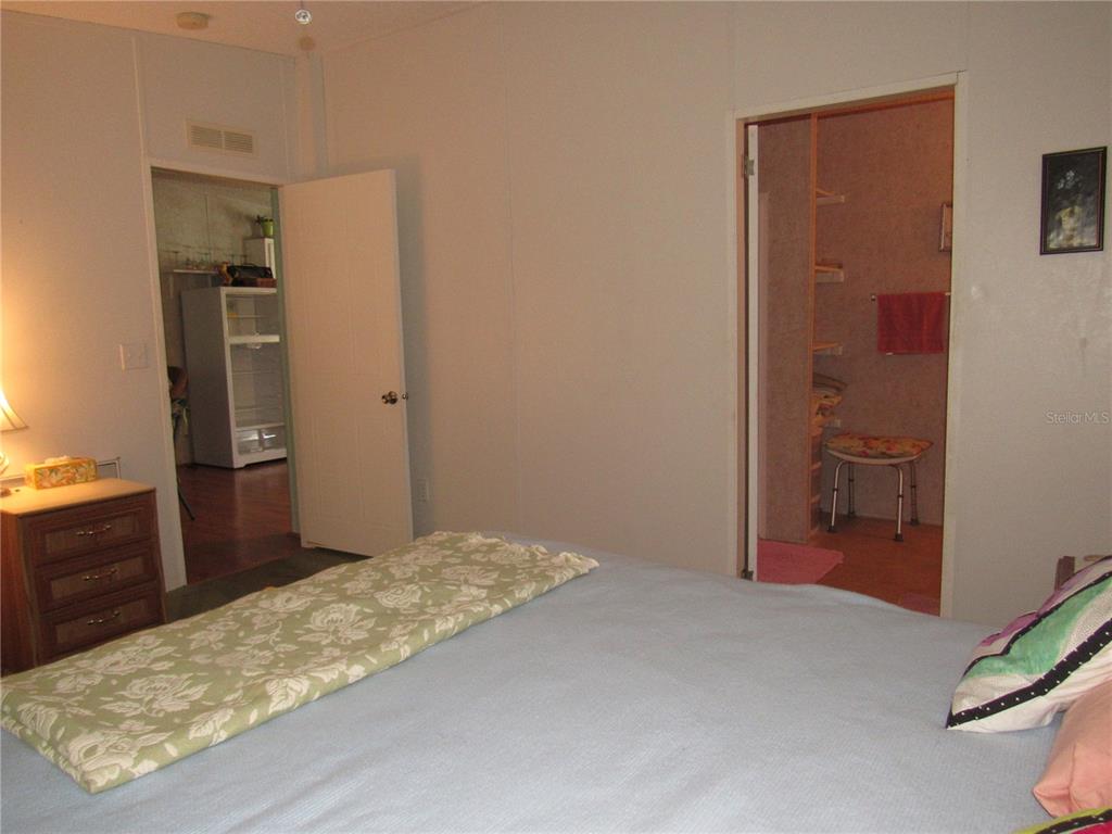 10101 Burnt Store Road, Unit 52 Punta Gorda, FL 33950 - Photo 13 of 37 a bedroom with a bed and a dresser