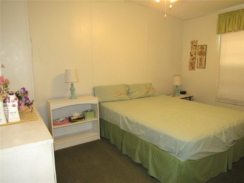 10101 Burnt Store Road, Unit 52 Punta Gorda, FL 33950 - Photo 16 of 37 a bedroom with a bed and a cabinets