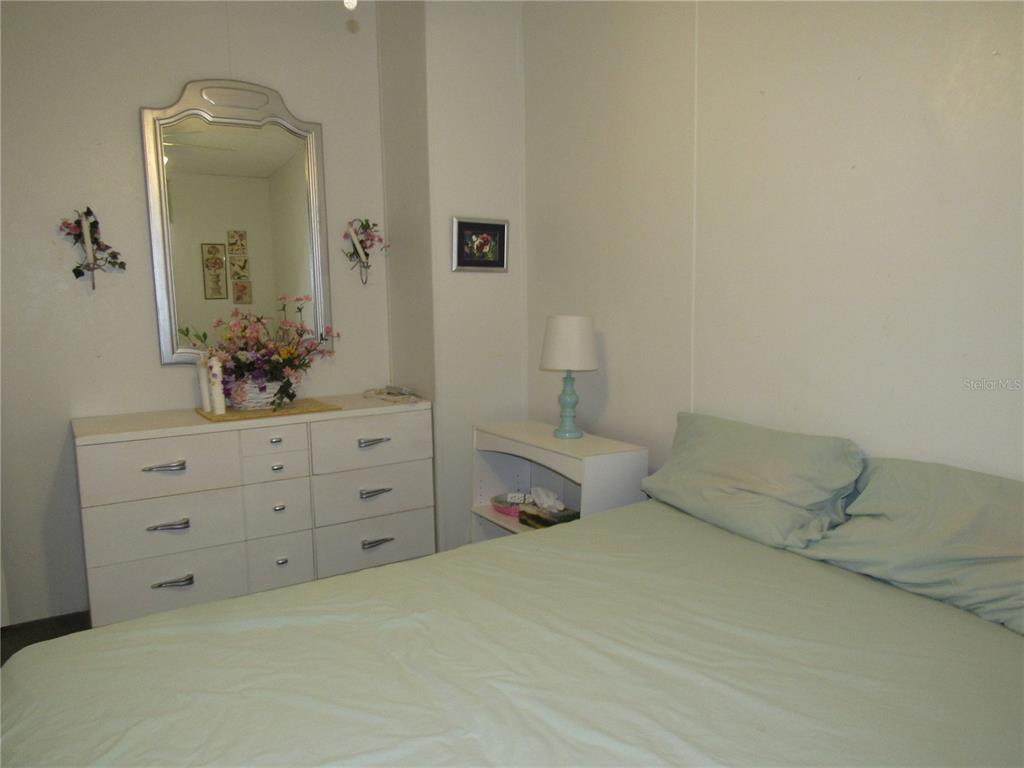 10101 Burnt Store Road, Unit 52 Punta Gorda, FL 33950 - Photo 17 of 37 a bedroom with a bed and a mirror on dresser