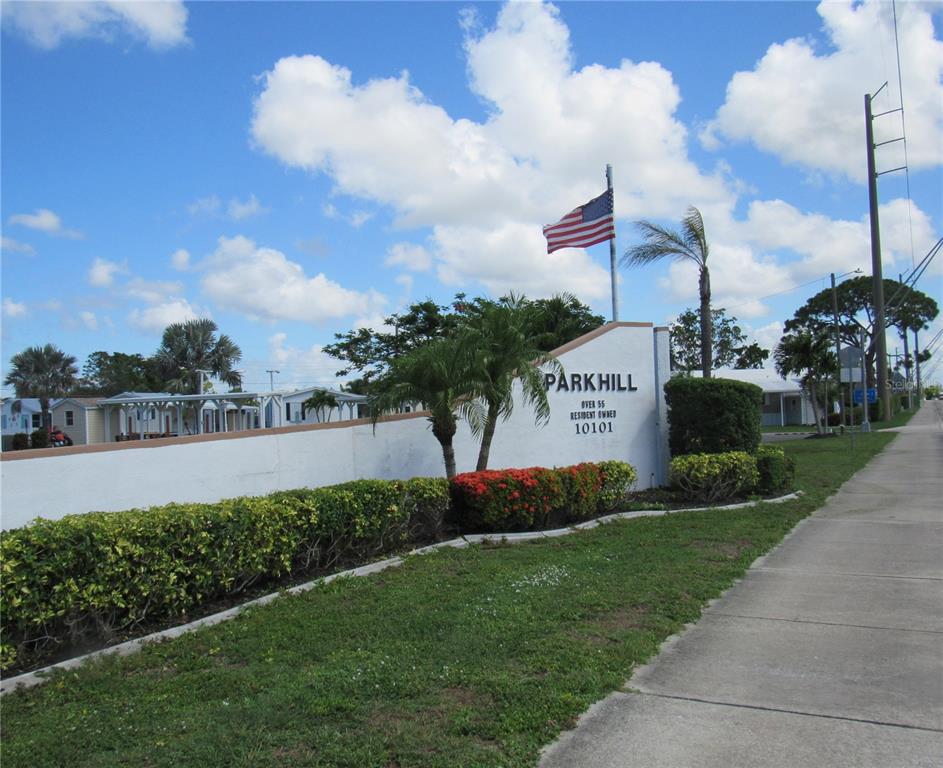 10101 Burnt Store Road, Unit 52 Punta Gorda, FL 33950 - Photo 22 of 37 a view of a street with a big yard and potted plants