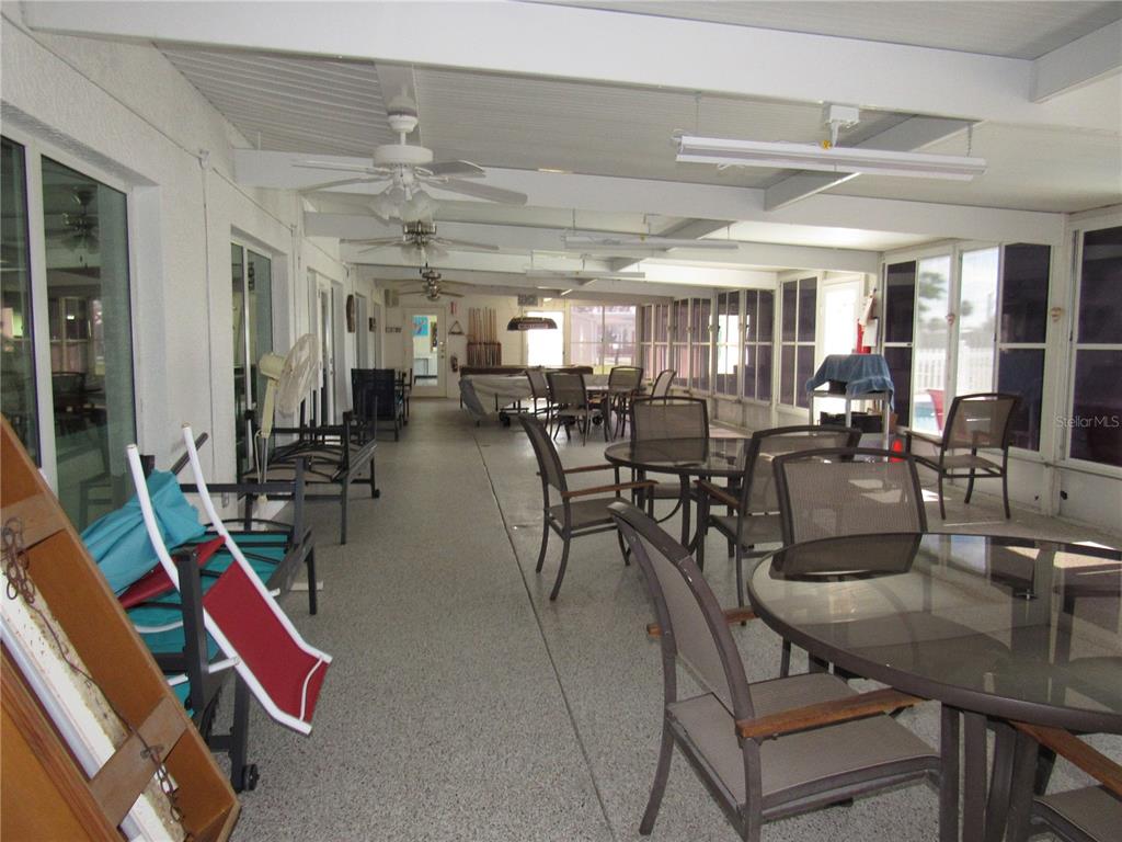 10101 Burnt Store Road, Unit 52 Punta Gorda, FL 33950 - Photo 24 of 37 a view of a dining hall with lots of furniture and windows