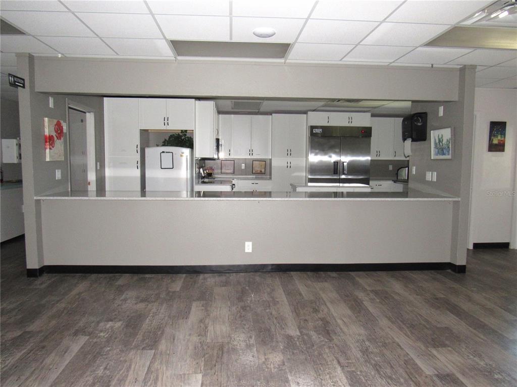 10101 Burnt Store Road, Unit 52 Punta Gorda, FL 33950 - Photo 26 of 37 a living room with stainless steel appliances a wooden floor