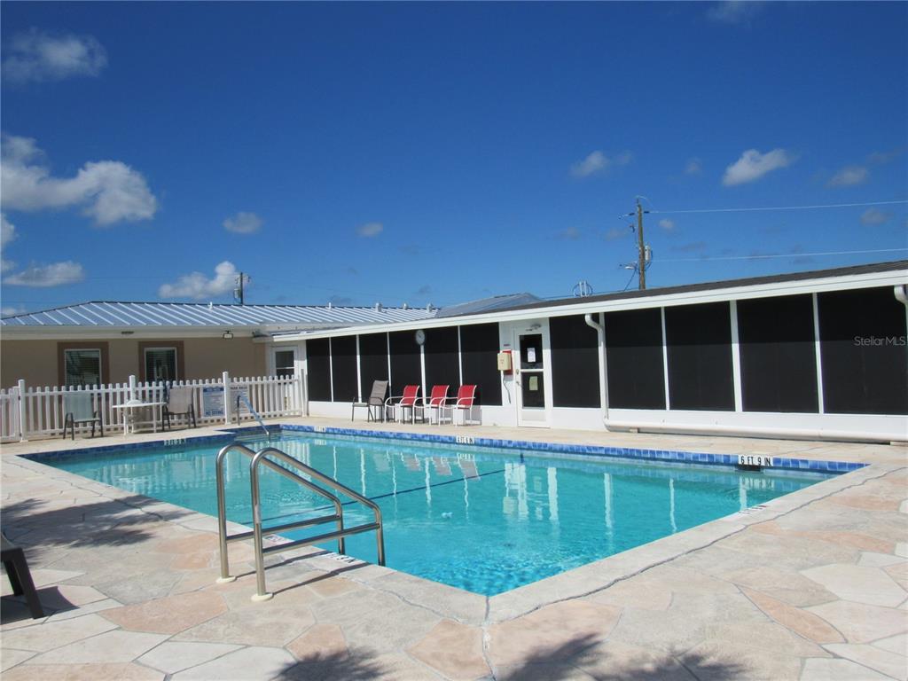 10101 Burnt Store Road, Unit 52 Punta Gorda, FL 33950 - Photo 36 of 37 a view of a house with a swimming pool and sitting area