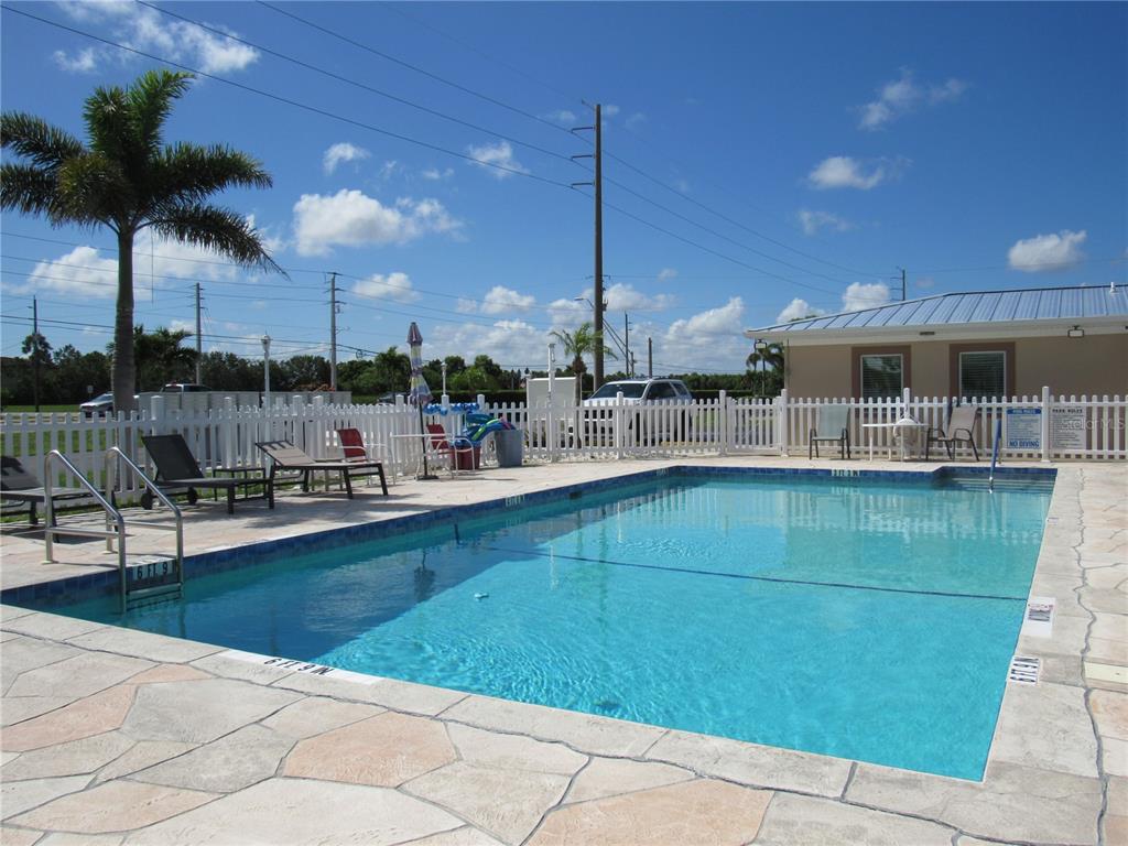10101 Burnt Store Road, Unit 52 Punta Gorda, FL 33950 - Photo 37 of 37 a view of a swimming pool with a lounge chair