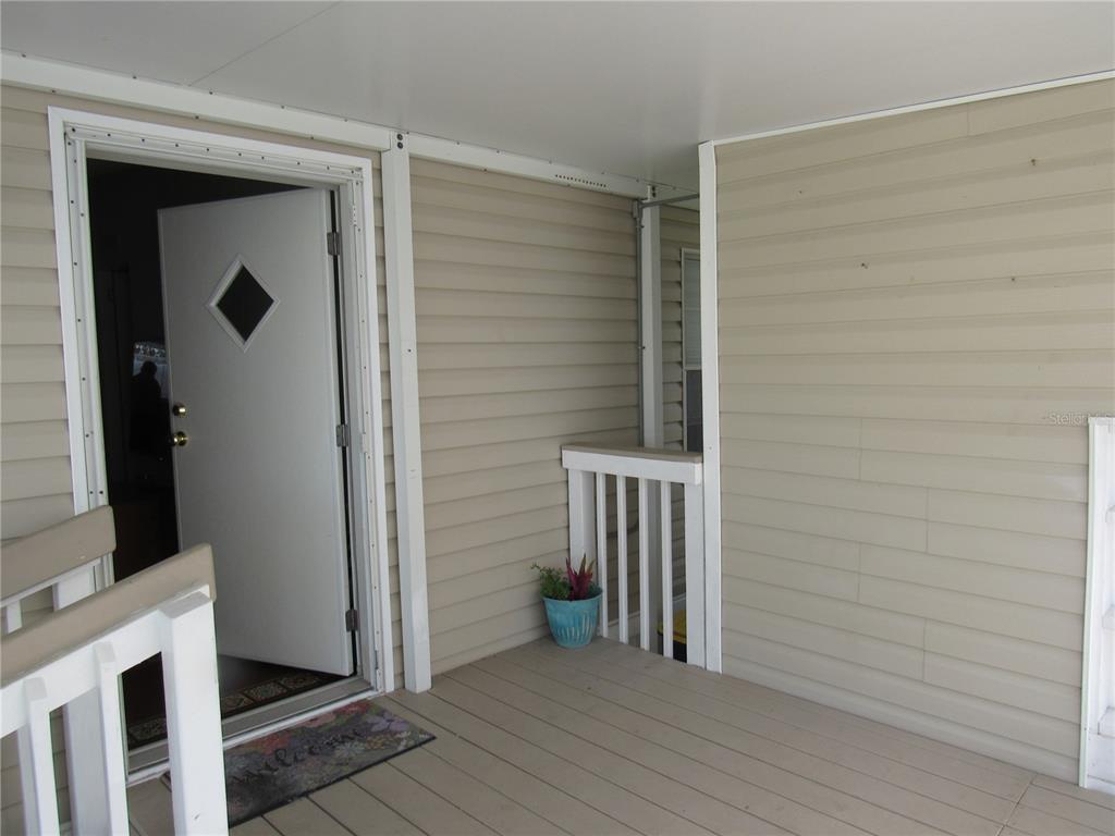 10101 Burnt Store Road, Unit 52 Punta Gorda, FL 33950 - Photo 5 of 37 a view of a livingroom with wooden floor and a fireplace