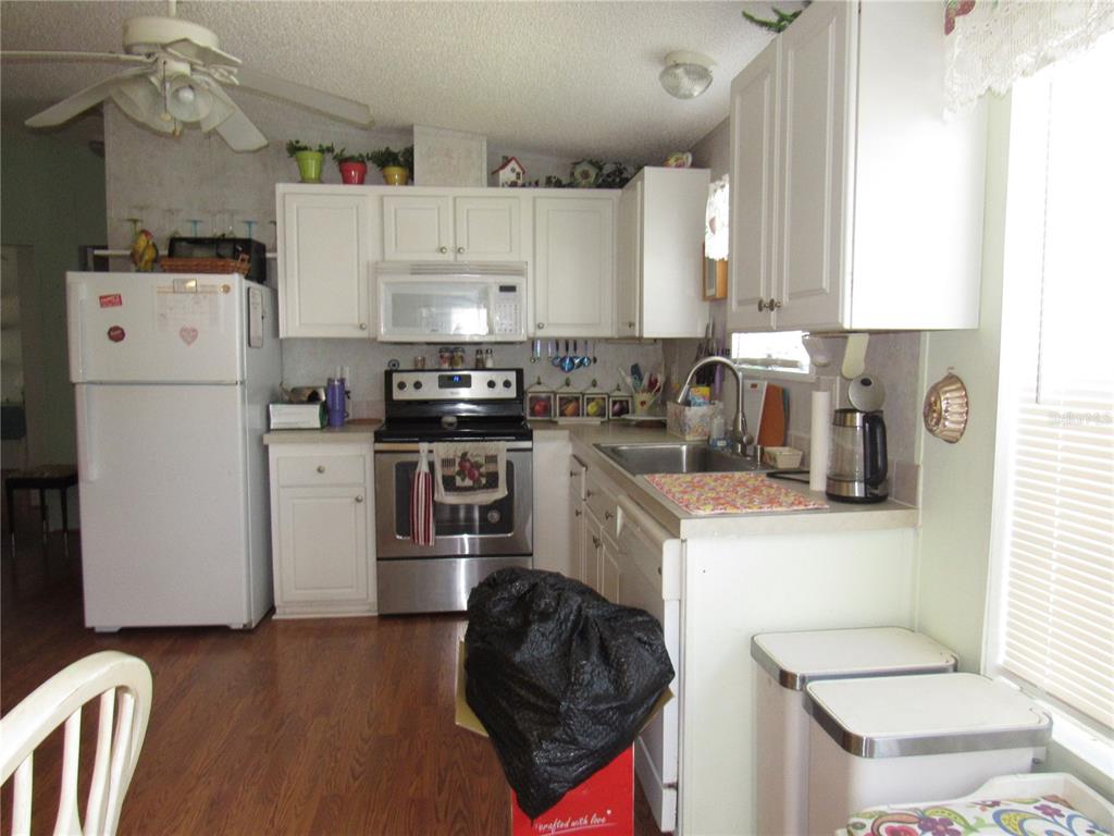 10101 Burnt Store Road, Unit 52 Punta Gorda, FL 33950 - Photo 9 of 37 a kitchen with a sink a stove and refrigerator