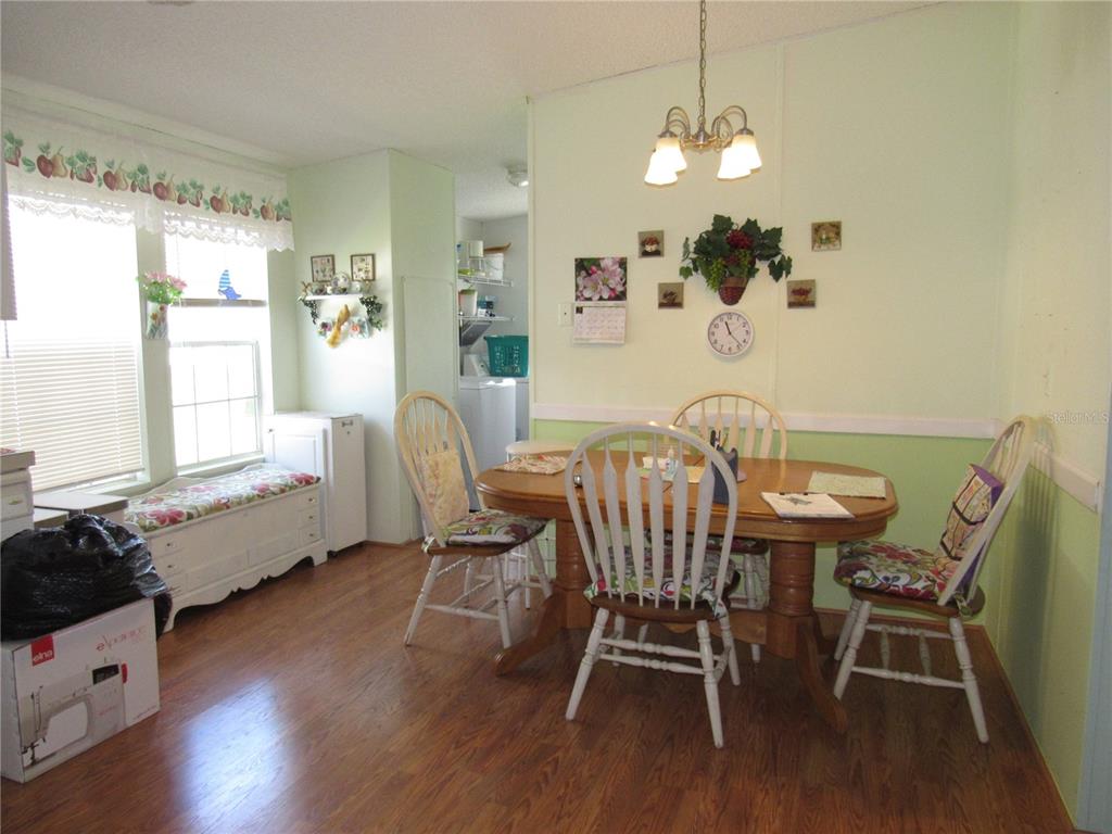 10101 Burnt Store Road, Unit 52 Punta Gorda, FL 33950 - Photo 10 of 37 a view of a dining room with furniture and wooden floor