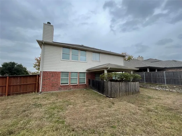 front view of a house with a yard and garage
