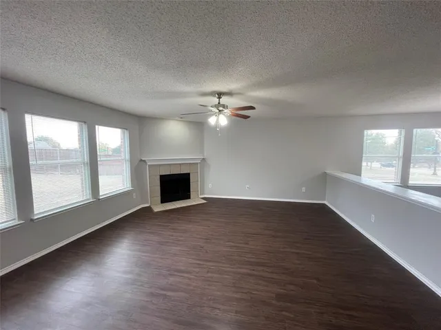 a view of a livingroom with a ceiling fan and window