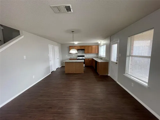 a view of kitchen and hall with wooden floor