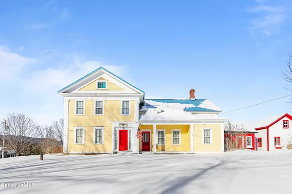 a view of a white house with large windows