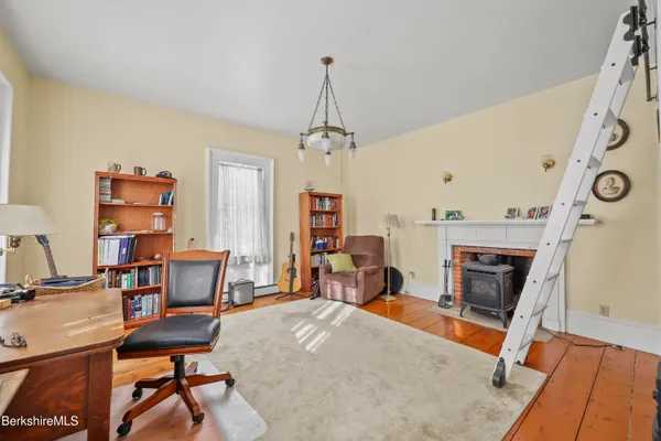 a living room with furniture and a book shelf