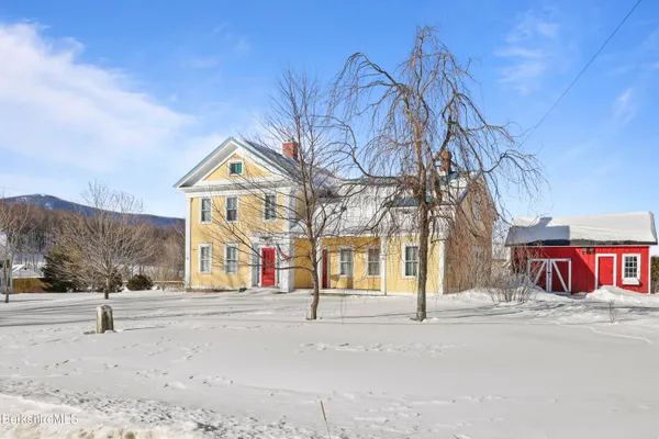 a front view of a house with large windows
